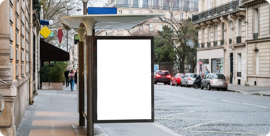 Empty bus stop advertisement on city street.
